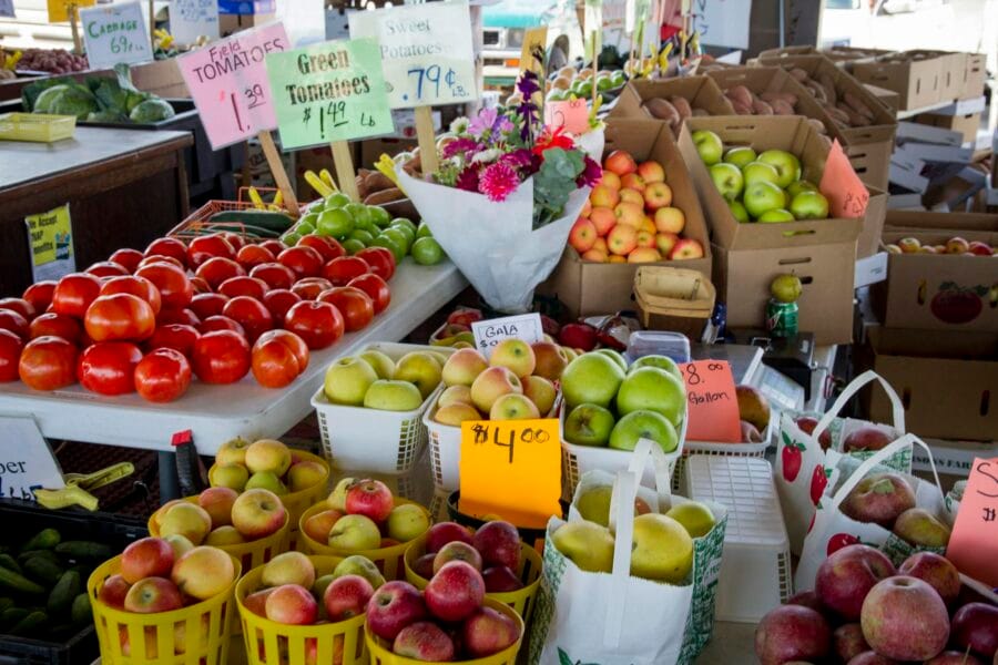 Fresh fruits and vegetables for sale at a North Carolina farmers market stall.