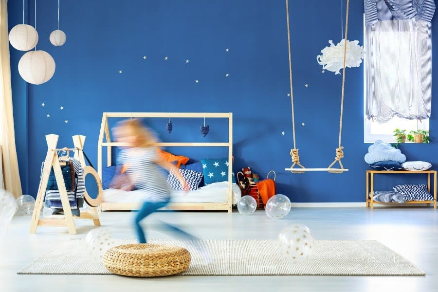 Child bedroom with navy blue wall, wood bed and swing