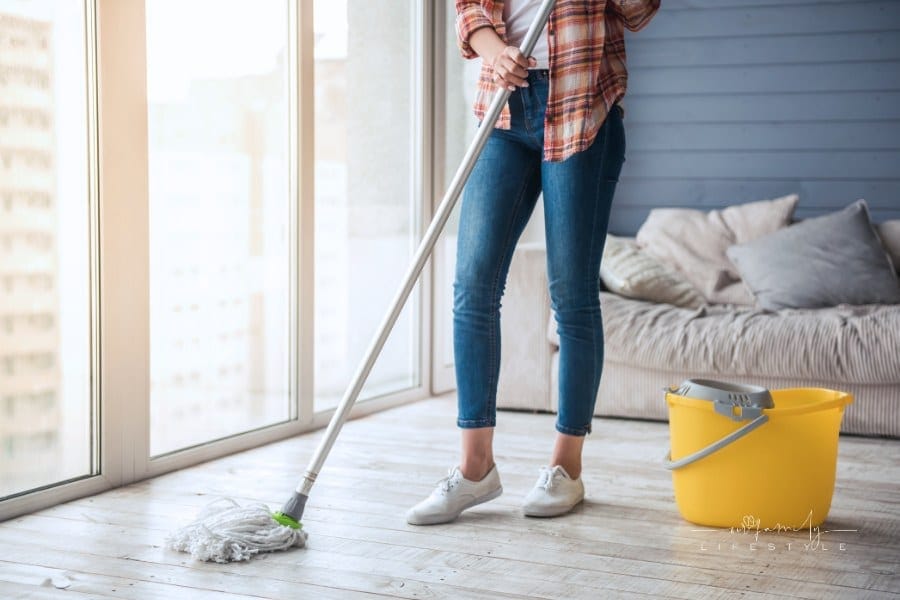 woman cleaning floor at home using a mop