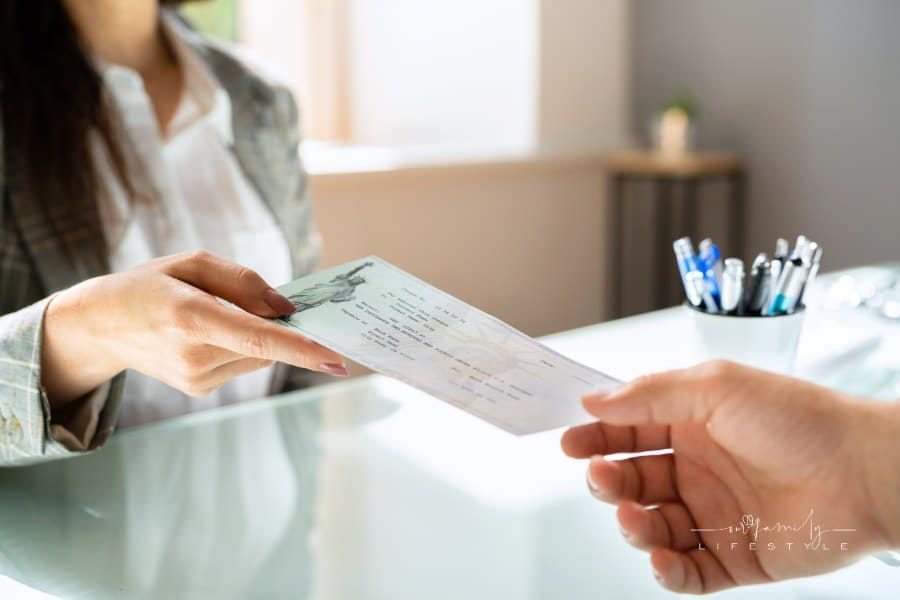Woman Handing Over Payroll Compensation Check. Bank Paycheck