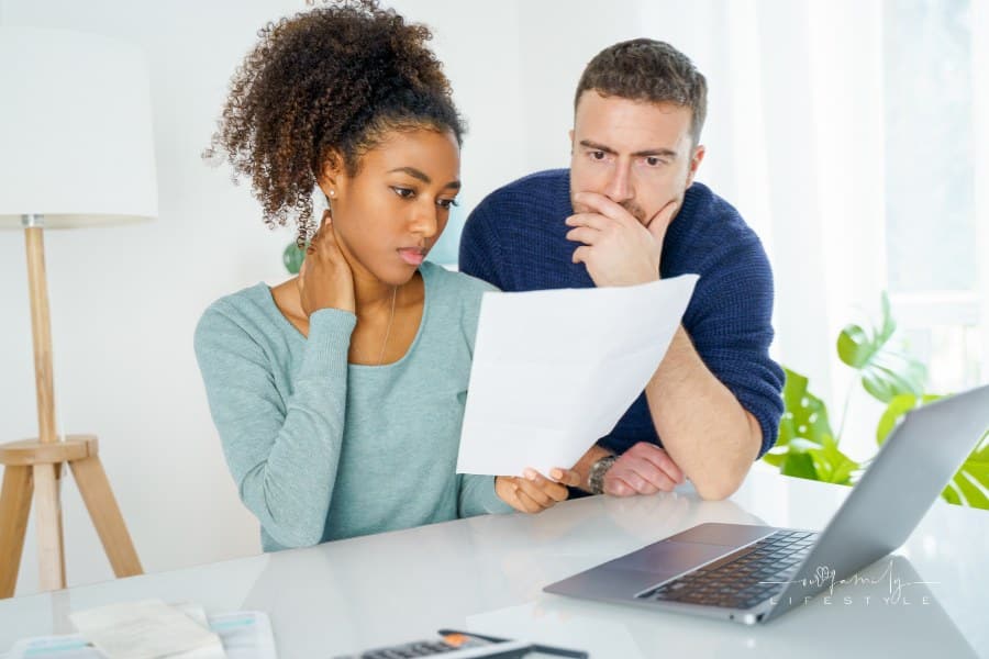 Multiethnic couple worried about family budget and monthly expenses