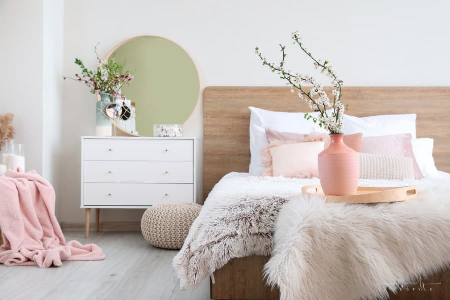 Interior of beautiful modern bedroom with spring flowers