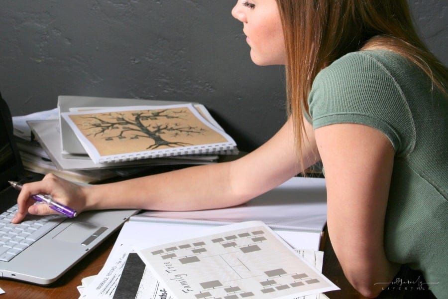 woman looking at genealogy and family tree on laptop