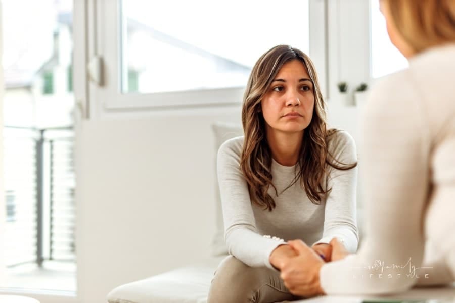 worried woman discussing her depression with another woman