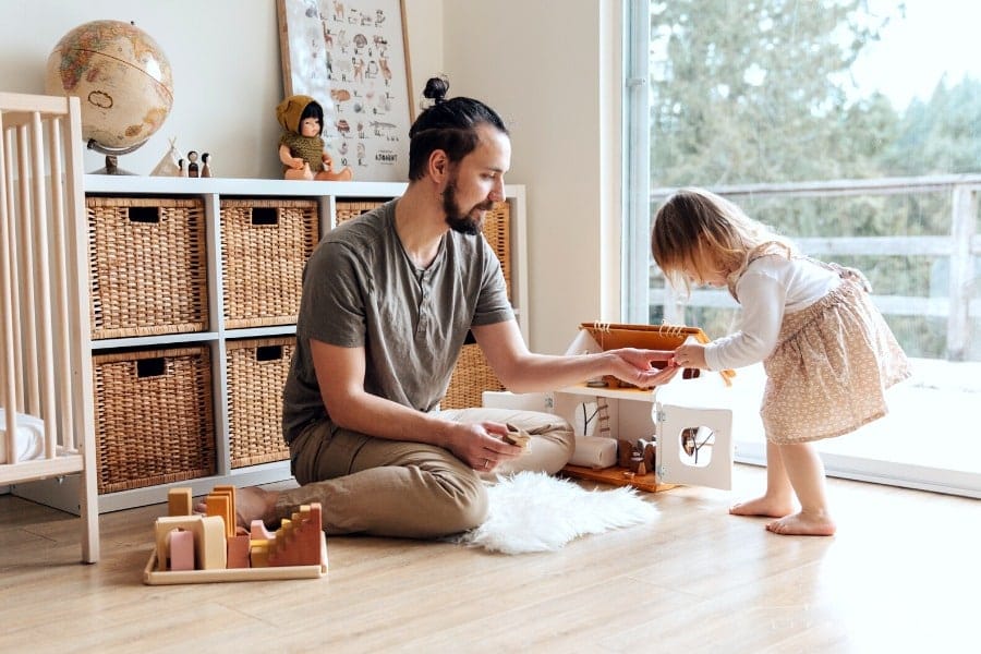 dad and daughter playing toys together