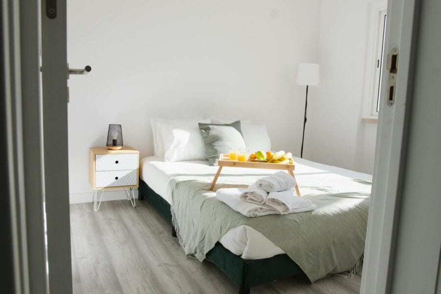 Inviting bedroom interior featuring a comfortable bed with a breakfast tray and stylish decor.
