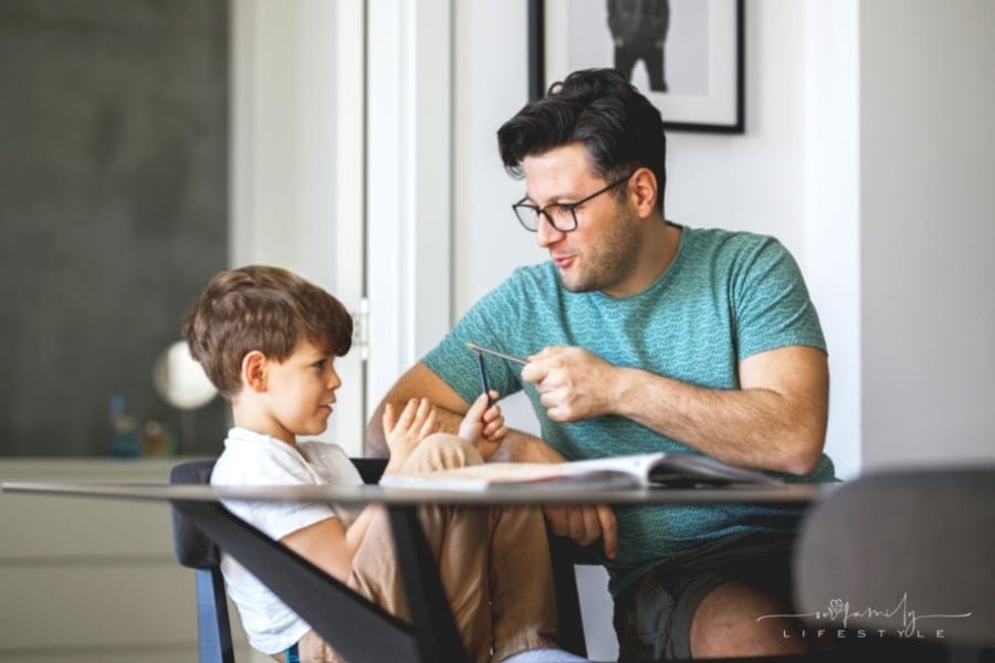 father homeschooling his son