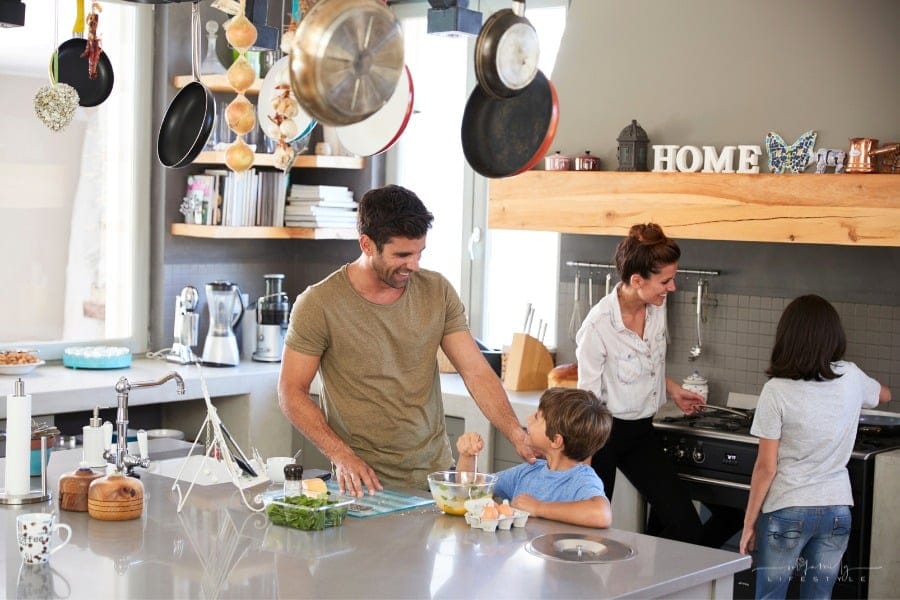 mom and dad cooking in kitchen with son and daughter
