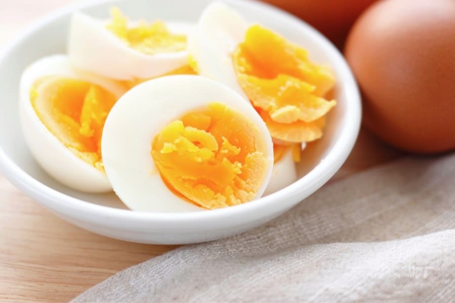 Sliced-hard boiled eggs in small white dish