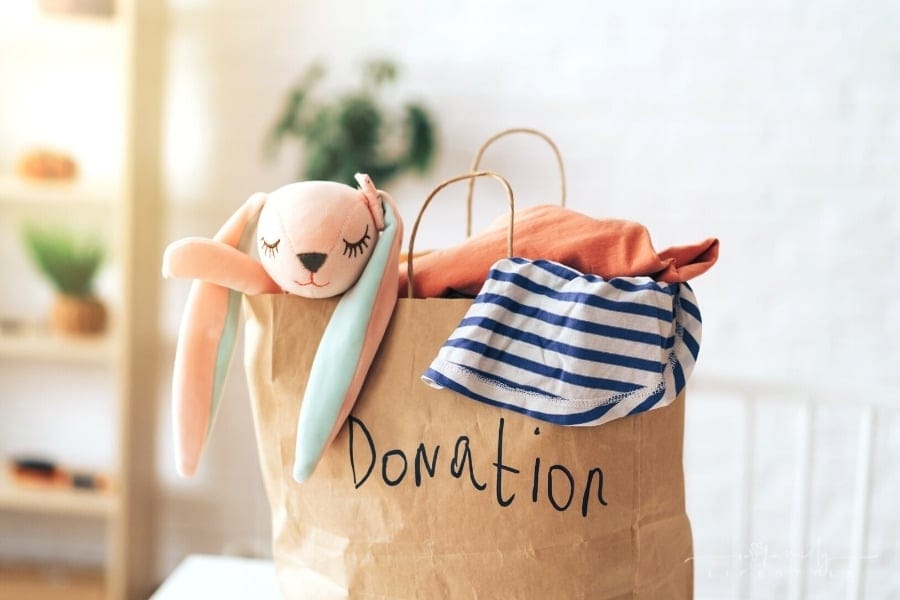 paper bag with old clothes and toys for donation