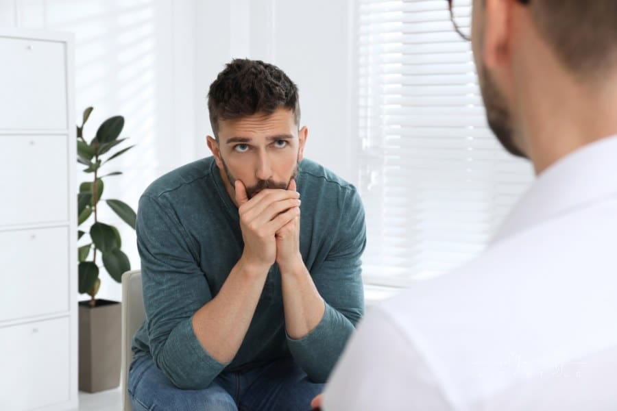 Psychotherapist Working with Drug Addicted Man Indoors