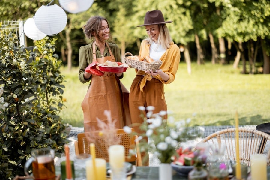 Friends prepare for the festive dinner at backyard of the house