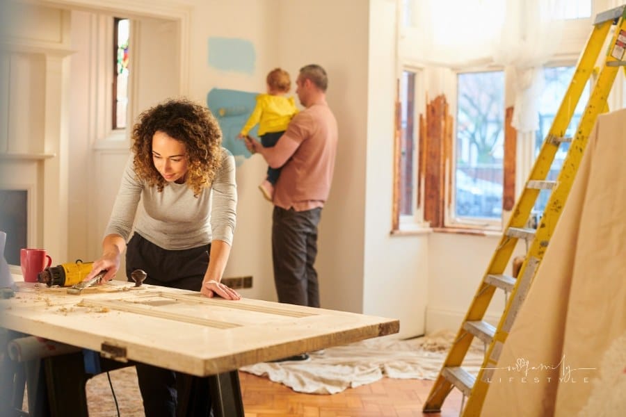 young couple with toddler working on home renovatin project