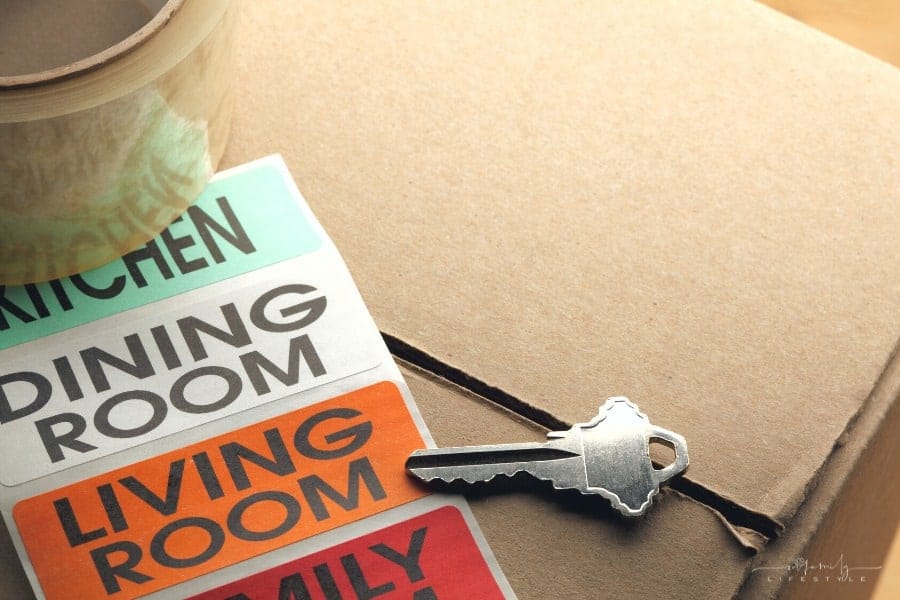 new house key on box with packing tape and color coded room labels