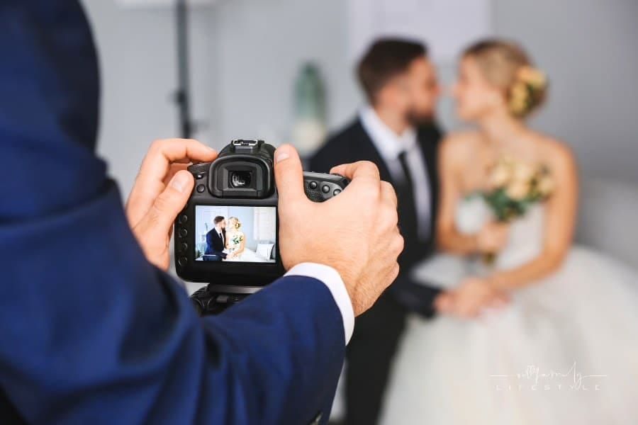 Photographer Working with Young Wedding Couple, Closeup of camera shot of bride and groom