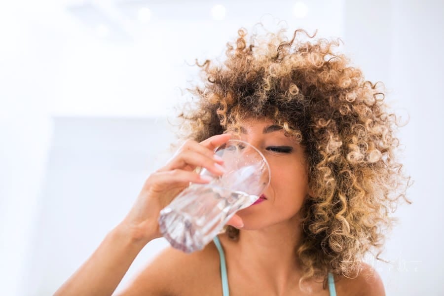 woman drinkning glass of water
