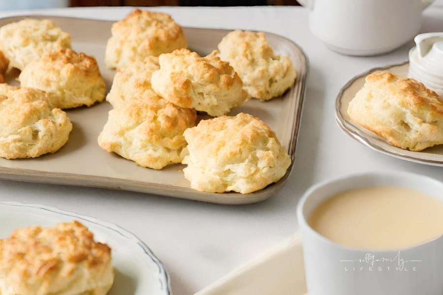 Bisquick Biscuits on a platter surrounded by coffee and other breakfast foods