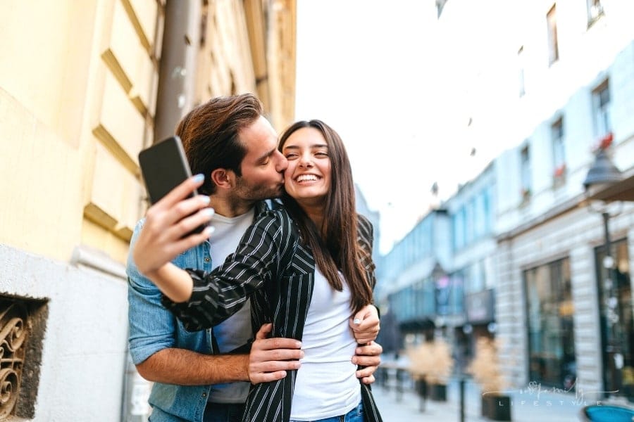 couple smiling taking a selfie while traveling