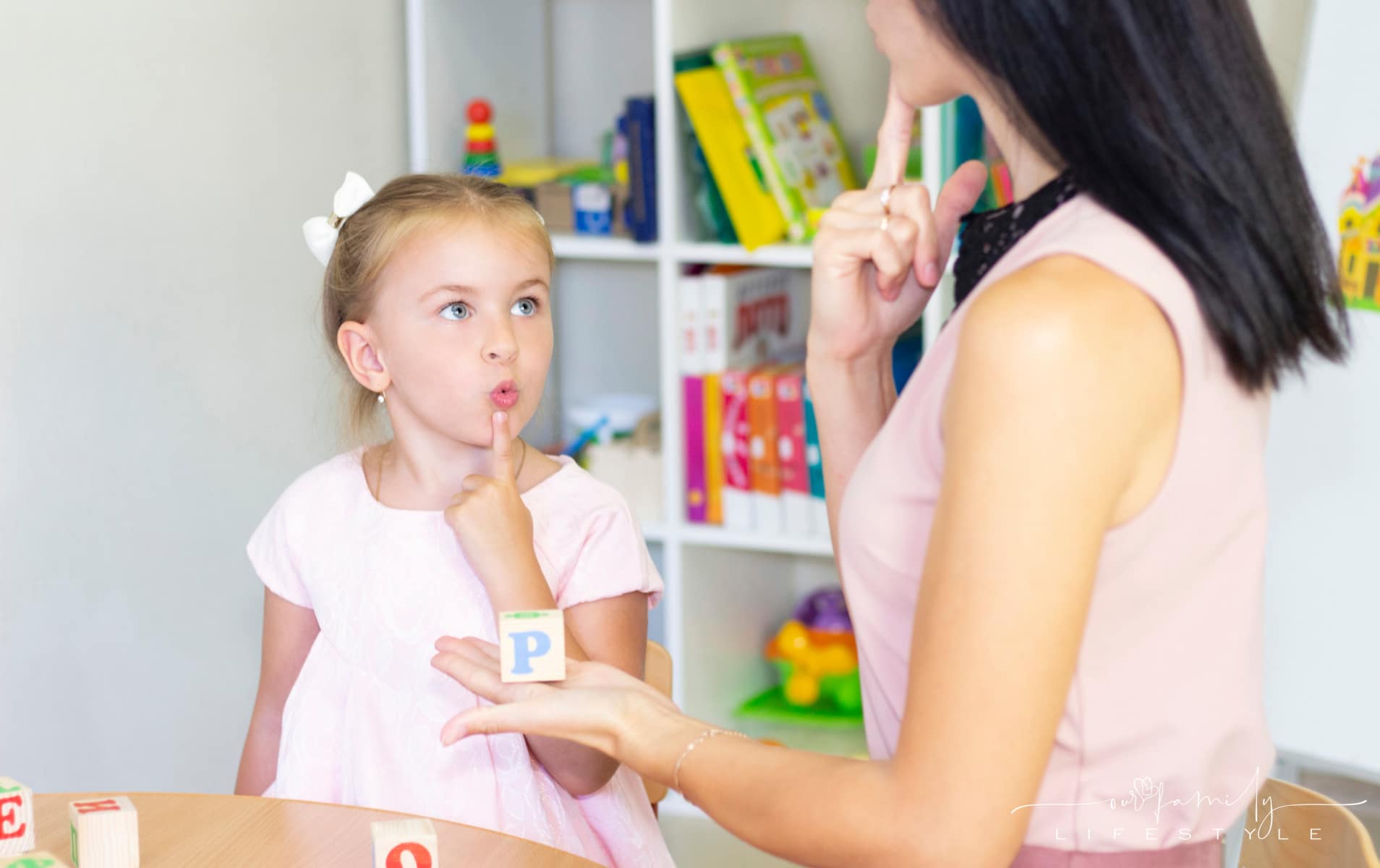 Speech therapist teaches the girl to say the letter