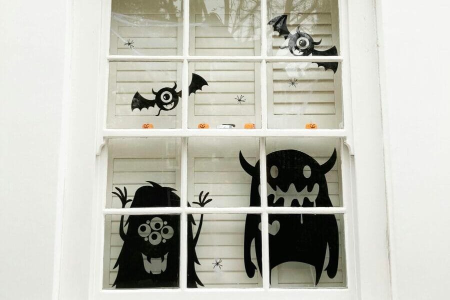 Spooky Halloween decorations featuring monsters and bats on a window in London.