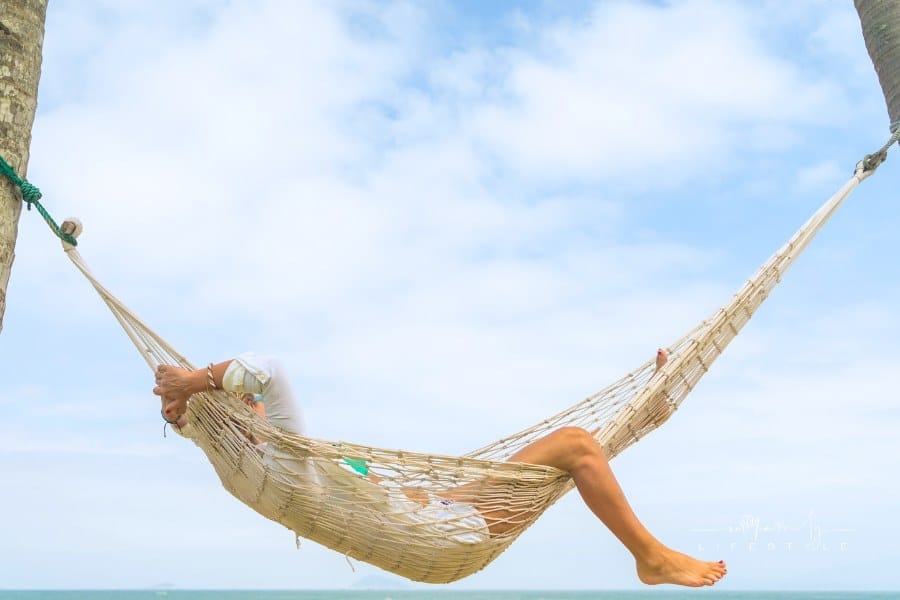 woman relaxing at the beach in a hammock
