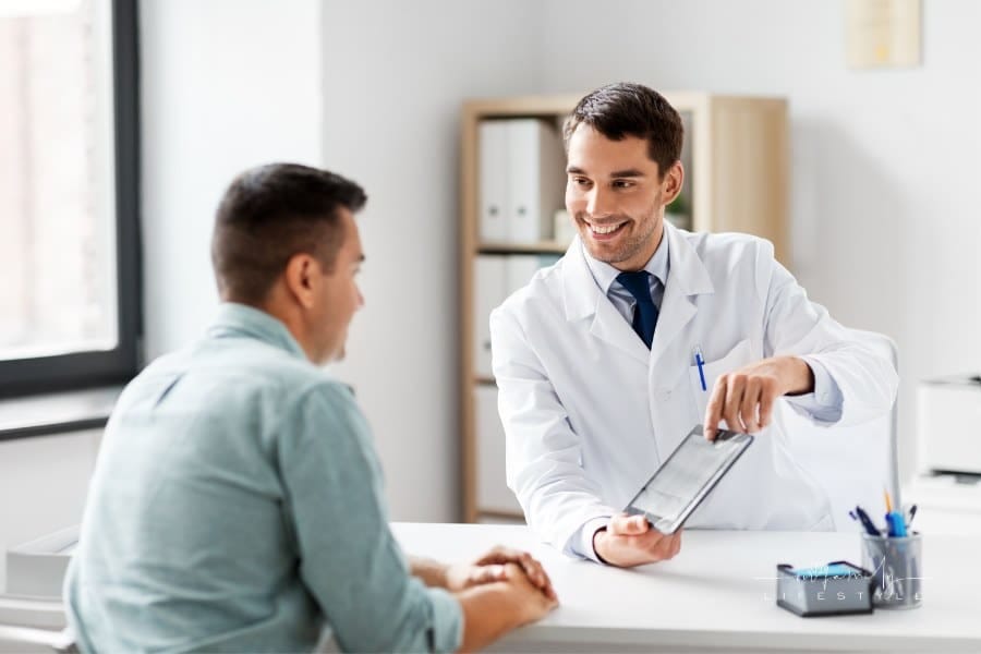 Doctor poiniting out details on tablet to Patient at hospital