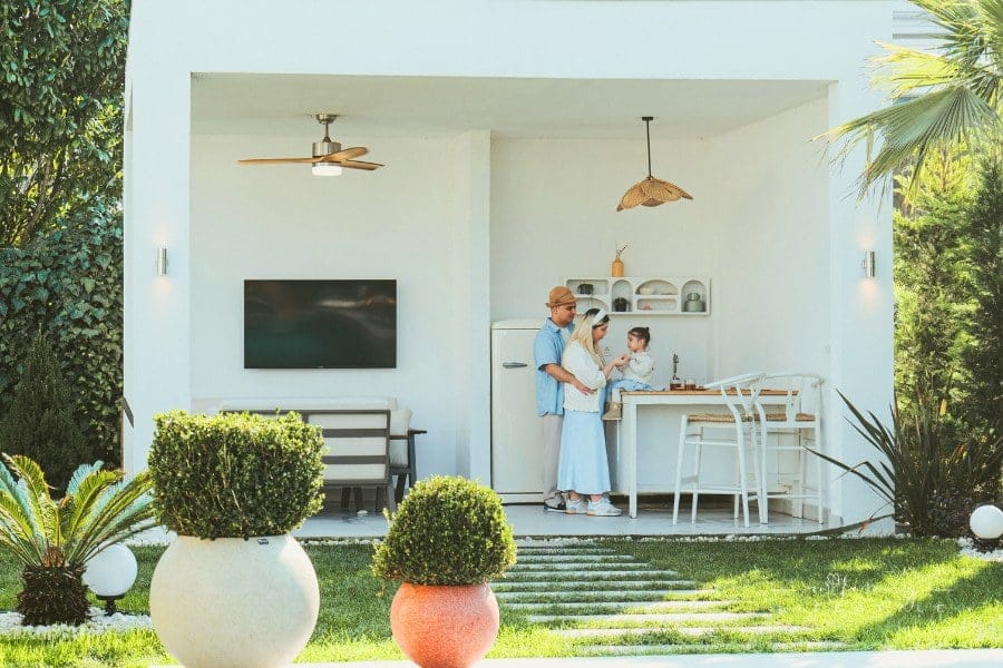 family of three in backyard kitchen space