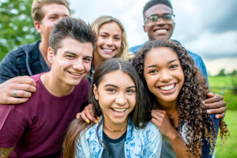 group of teens smiling together at camera