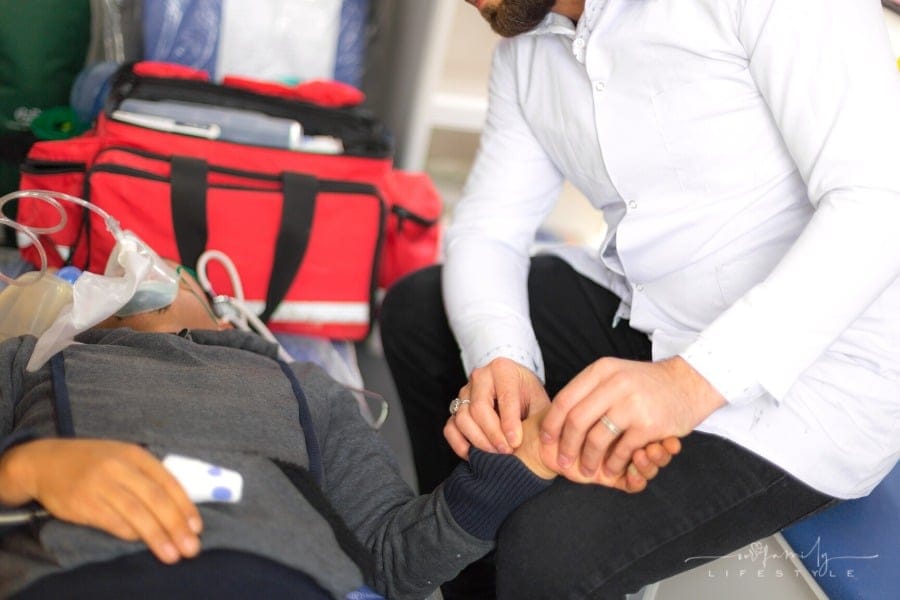 paramedic performing emergency services in ambulance