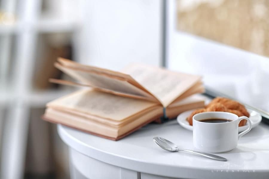 coffee, croissant and book on table