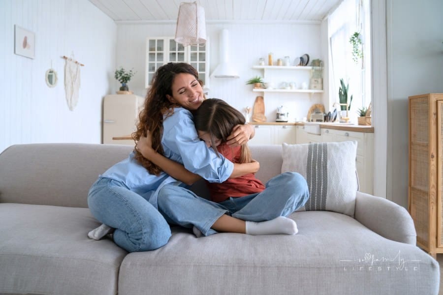Teen Girl Hugging Cuddling Happy Smiling Mother While Spending Time Together at Home