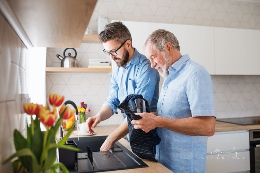 Elderly Father and Son Washing Dishes Together