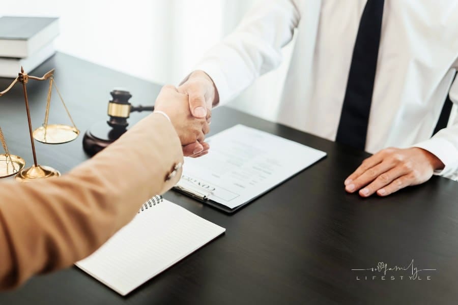 Lawyer shaking hand with client in law firm.